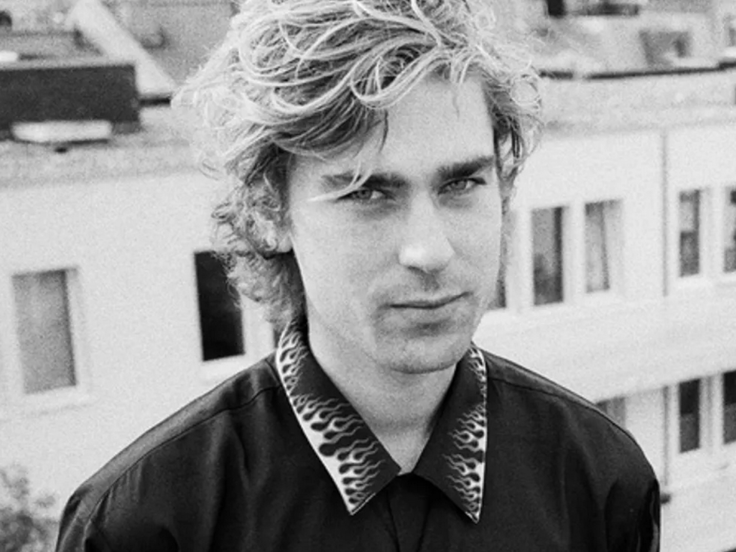 young man looking at camera from balcony