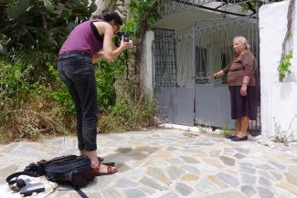Resident photographing an older inhabitant of the island of Crete.