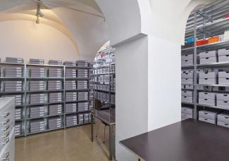 An archive in the vaulted basement with a pillar in the centre
