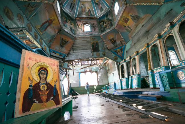Colourful destroyed space with various paintings and rubbish on the floor