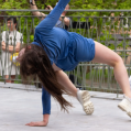 A performer dressed in blue performing in public space.