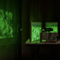 A gallery space functioning as a projection room with green screens