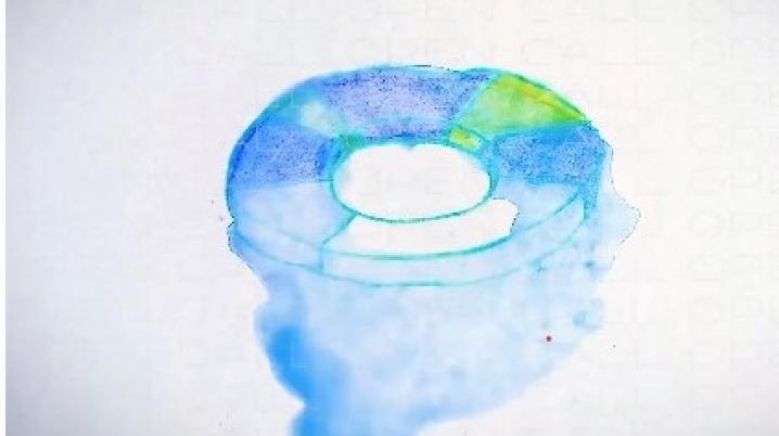 A fading circular object painted with yellow and blues in water colour