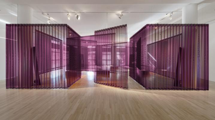 A purple spatial installation in a white cube gallery space.