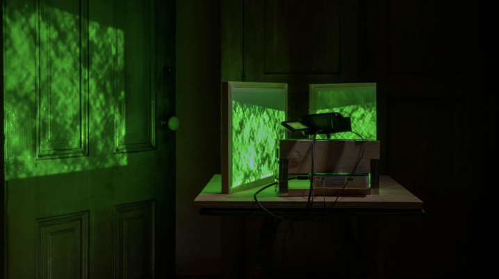 A gallery space functioning as a projection room with green screens