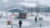 People walking in the snow on the EPFL campus grounds