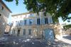 A blue villa on a sunny square in St Laurent des Arbres, France, where Echangeur22 is housed