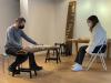 Two musicians playing traditional wooden snare instruments in a studio 
