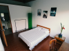 A bed with three framed picture on the wall and a desk
