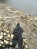 A shadow of the photographer on a muddy riverbank