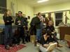 A group of artists looking at an instruction in an artists' studio
